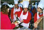 Volunteers work real hard - and with a smile - Volunteers work real hard - and with a smile -
providing hot meals.