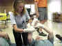 Elizabeth practices correct procedures for bandaging a wound.